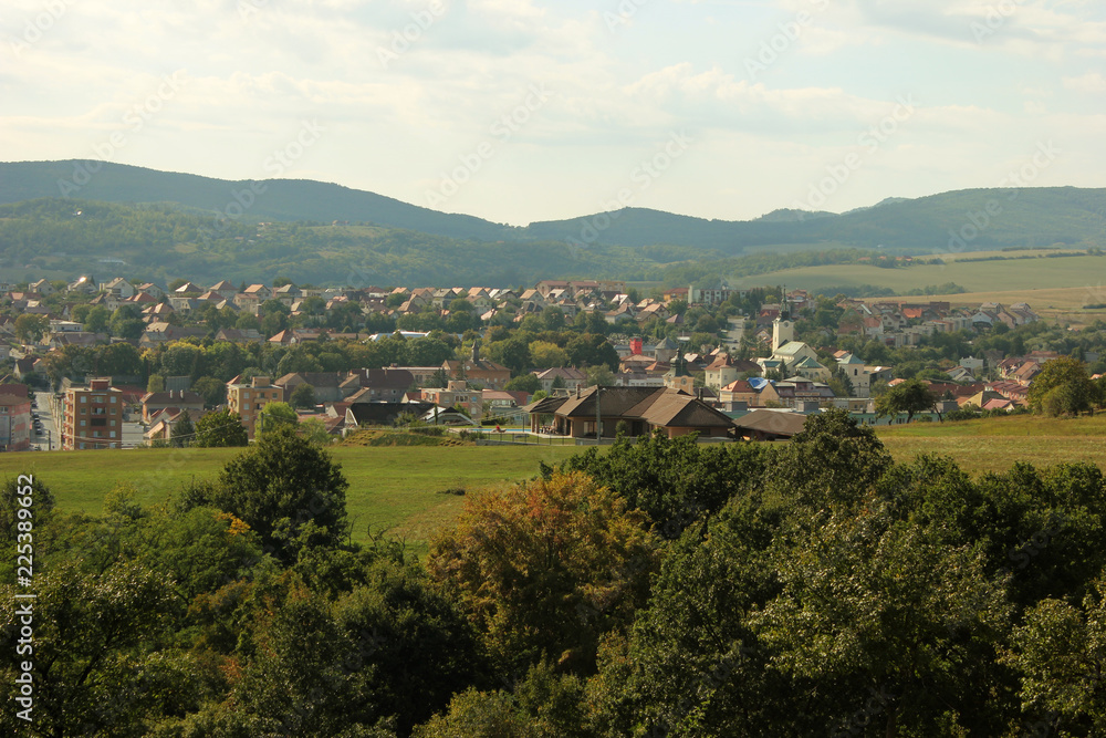 Fototapeta premium View of a little town with low mountains in the background