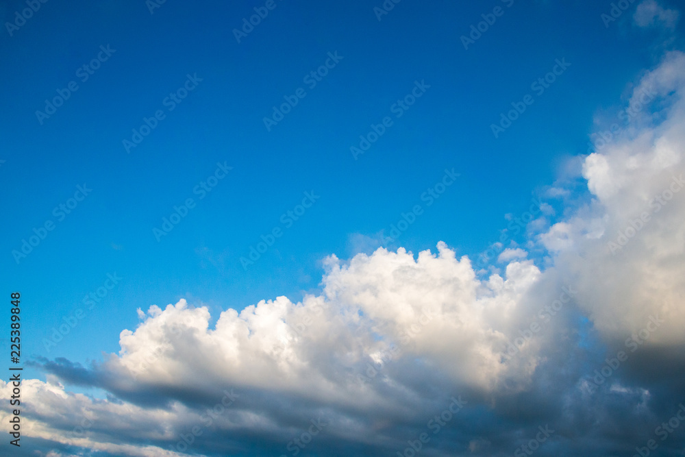 Blue sky cloudscape and white clouds background with sunbreams