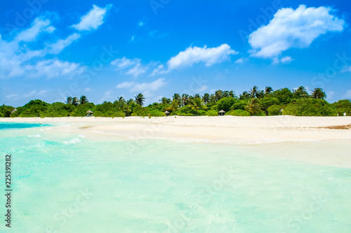 Beautiful sandy beach with sunbeds and umbrellas in Indian ocean, Maldives island © Myroslava