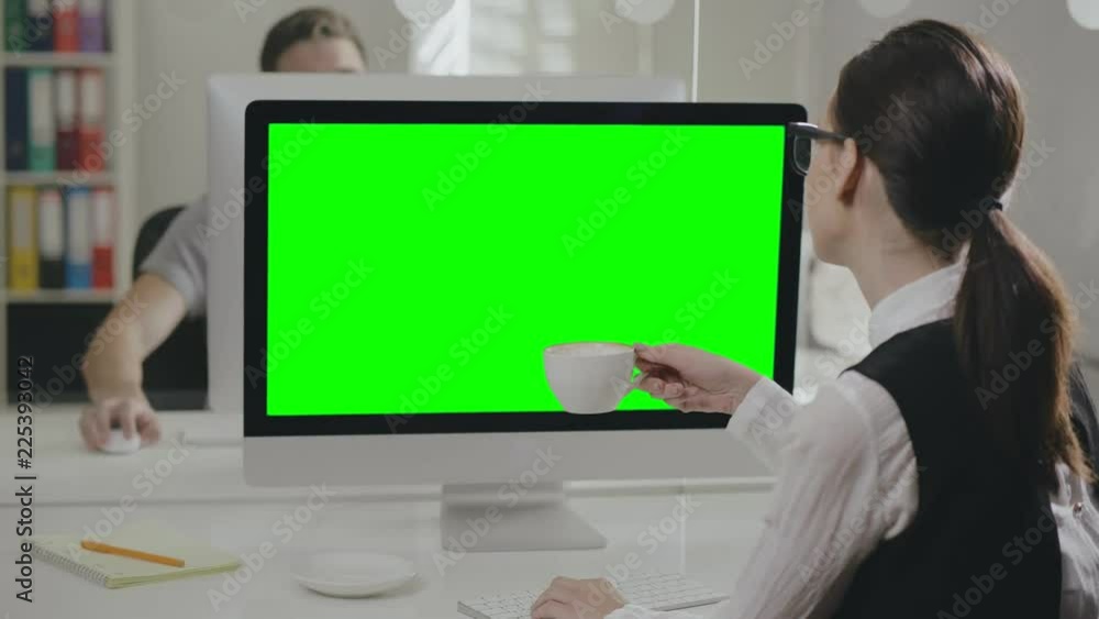 Portrait of female office employee typing on computer Portrait of female office employee typing on computer