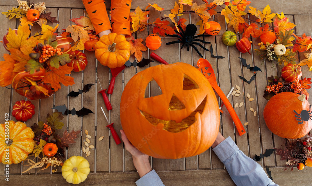 Fototapeta premium Family carving pumpkin. Halloween trick or treat
