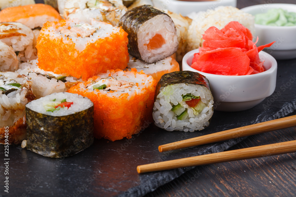 Sushi Roll with salmon, eel, tuna, avocado, cream cheese Philadelphia, caviar tobica, chuka. Sushi menu. Japanese food on table Sushi Roll with salmon, eel, tuna, avocado, cream cheese Philadelphia, caviar tobica, chuka. Sushi menu. Japanese food on table