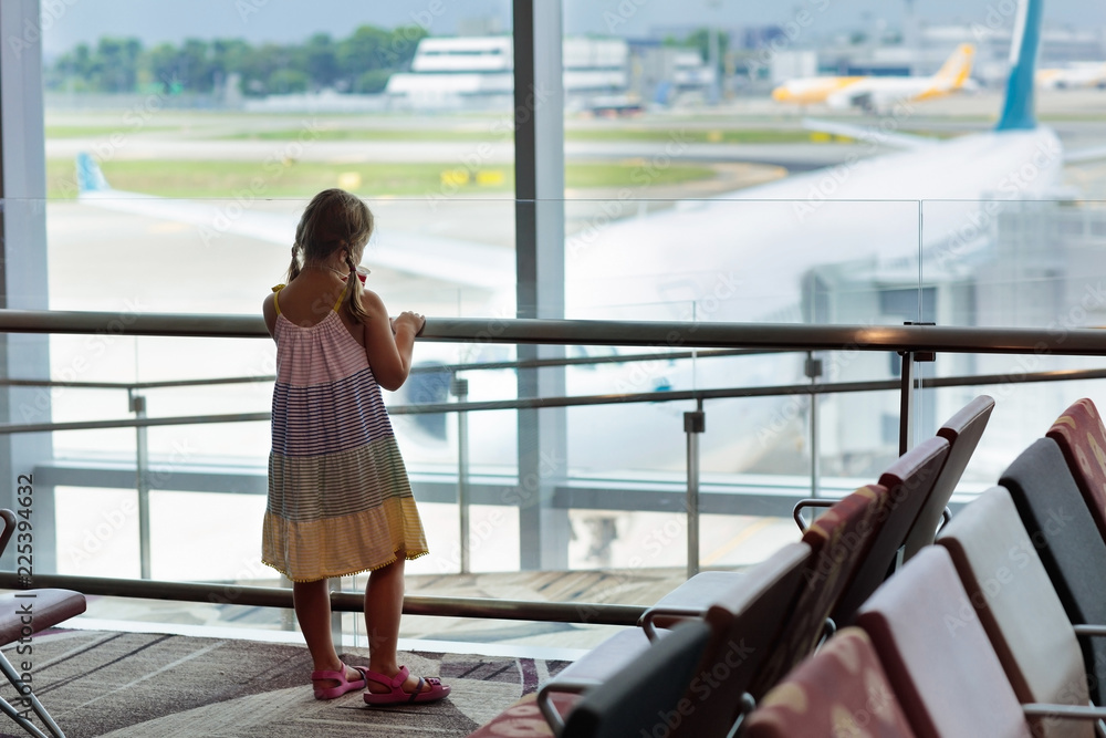 Kids travel and fly. Child at airplane in airport Kids travel and fly. Child at airplane in airport
