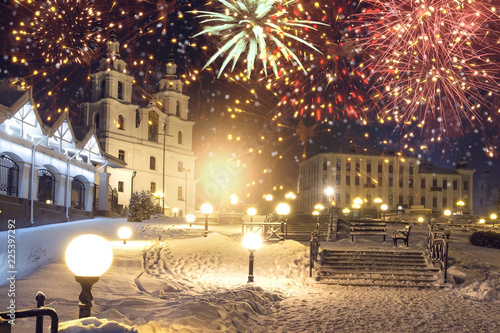 Festive fireworks in night Minsk, Belarus. Beautiful salute over Minsk city. Firework for celebration New Year and Christmas. Snowy Minsk on celebration. Xmas party.