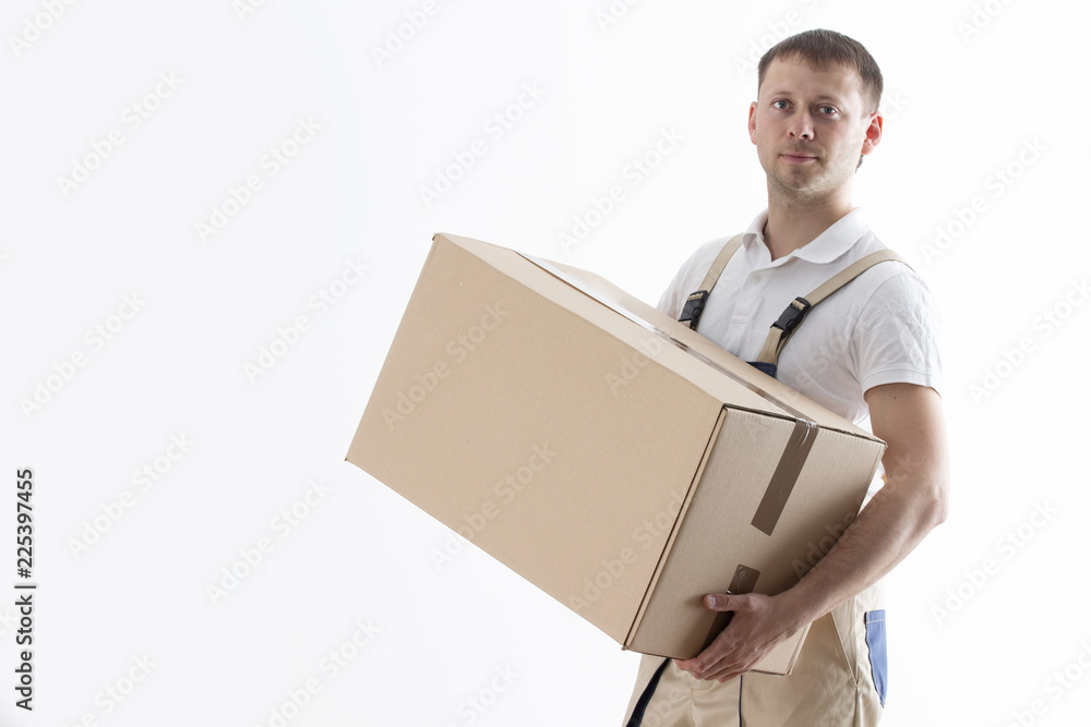 Portrait of man in uniform with cardboard box isolated on white background. Relocation service. Loader holds box. Male mover with parcel.