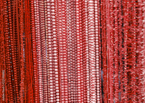 Necklaces with red and pink beads and corals in a jewelry store shop