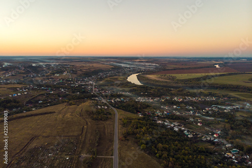 Aerial view of countryside village panorama in autumn sunset © DedMityay