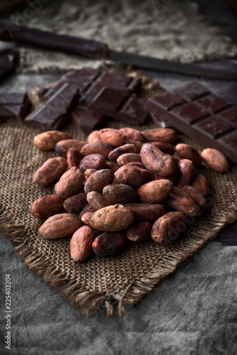 pile of cocoa seeds on rustic sackcloth in dark stage