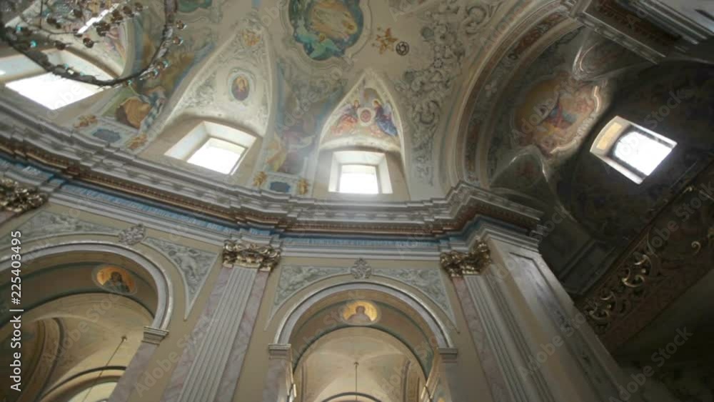 Fragment of the luxurious interior of the Catholic Church. The greatness and beauty of the frescoes on the ceiling and walls. Slow motion Fragment of the luxurious interior of the Catholic Church. The greatness and beauty of the frescoes on the ceiling and walls. Slow motion