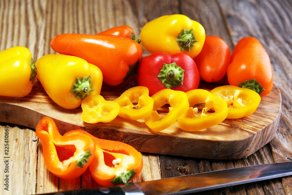 Fresh red, yellow and orange bell pepper on wooden background. raw vegetable. Fresh red, yellow and orange bell pepper on wooden background. raw vegetable.