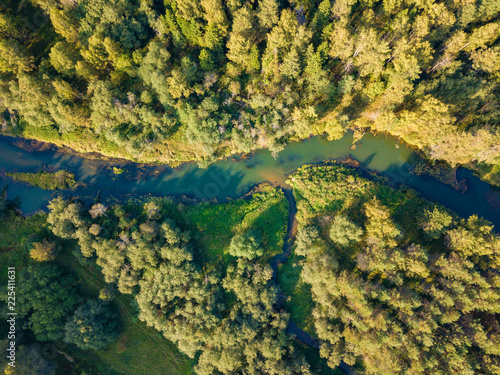 Aerial view of small river inflowing to big. Autumn forest.