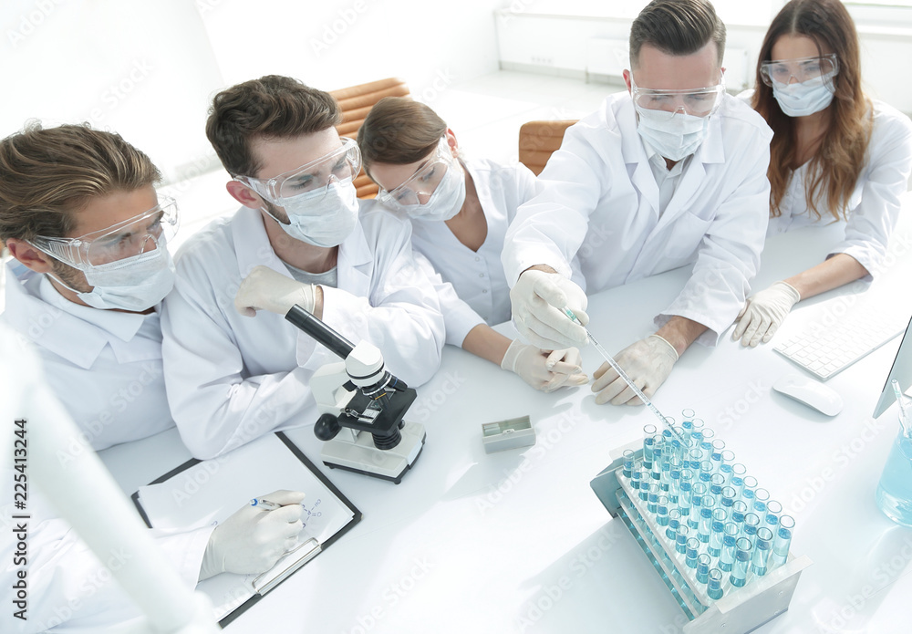 Fototapeta premium medical doctors are working with test tubes and microscope at the lab