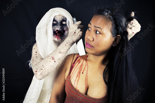 Evil Demon Zombie Ghost Monster Stabbing A Woman In The Neck Isolated On Black Background