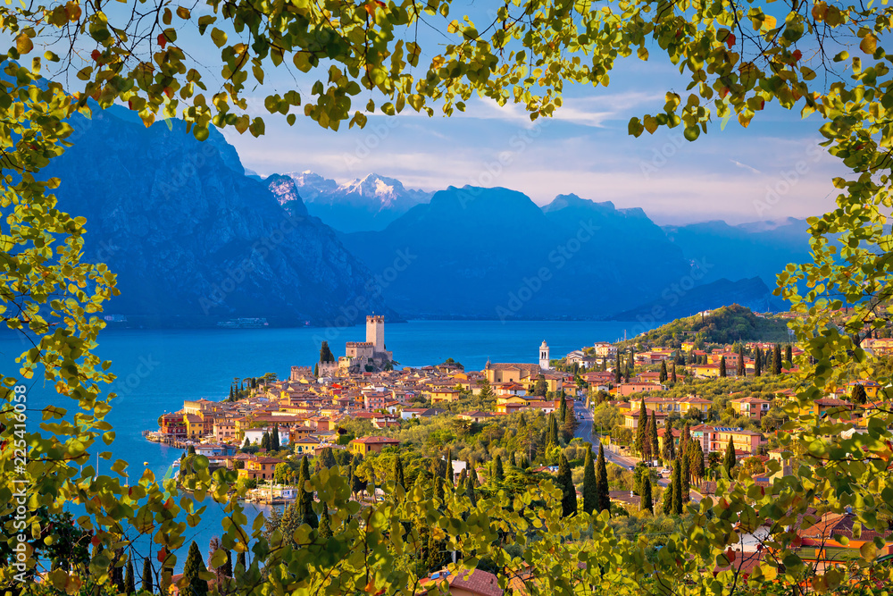 Town of Malcesine on Lago di Garda skyline viewthrough leaves frame