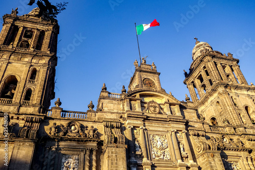 The Metropolitan Cathedral of Mexico City, with a Mexican flag flying above it photo