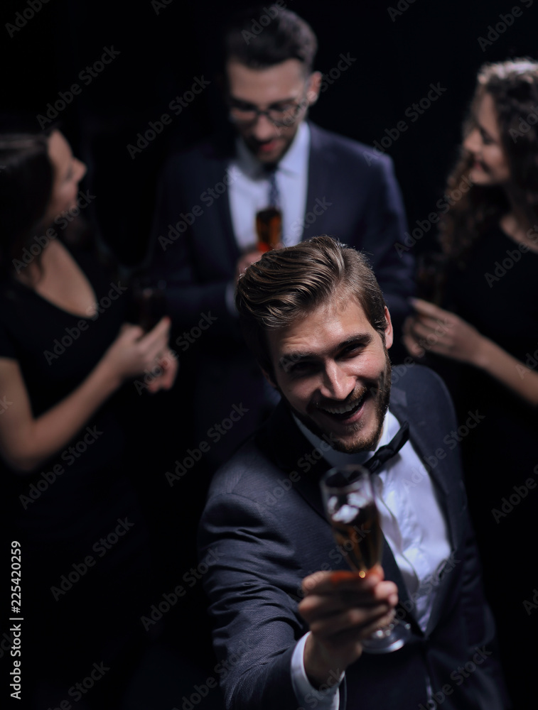 stylish young man raising a glass of wine