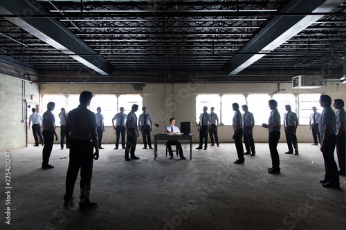 Man working at desk surrounded by clones