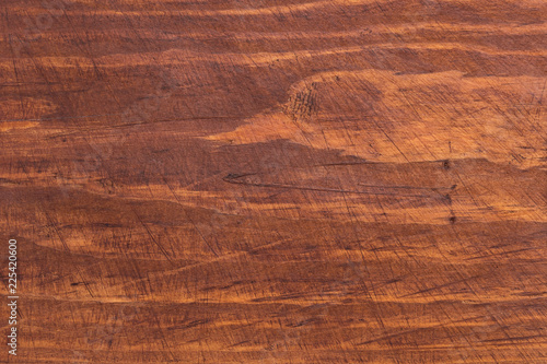 The surface of the wood cutting Board with traces of use.