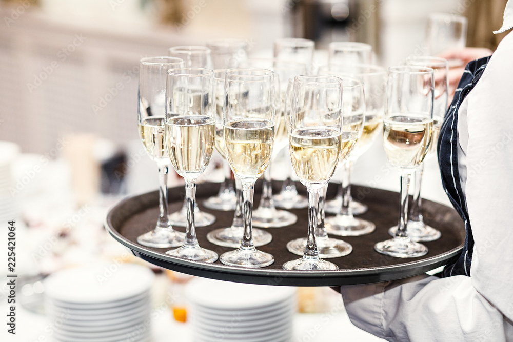 Elegant glasses with champagne standing in a row on serving tabl Elegant glasses with champagne standing in a row on serving tabl