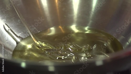 Slow motion shot of hot oil being prepared for frying photo