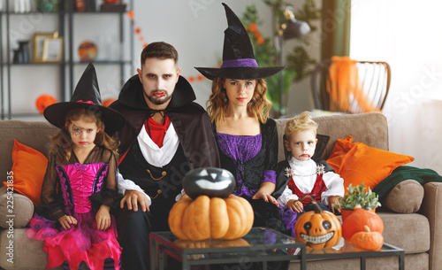 happy family mother father and children in costumes and makeup on Halloween