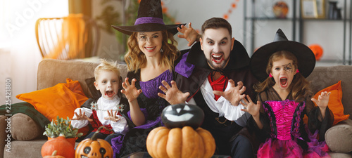 happy family mother father and children in costumes and makeup on Halloween