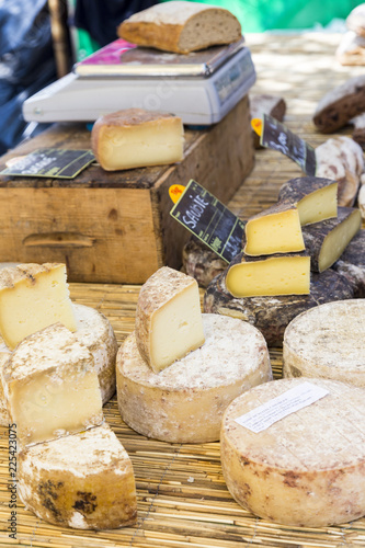 Rustic table of French cheeses at a market in Arles, Provence, France