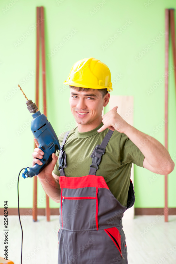 Young man carpenter working in workshop Young man carpenter working in workshop