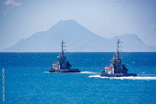 Photography Two Tugboats Cruising Out to Sea Towards Hazy Hills