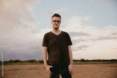 Handsome Young Male Model in Glasses and V-neck Modeling in Open Field Background
