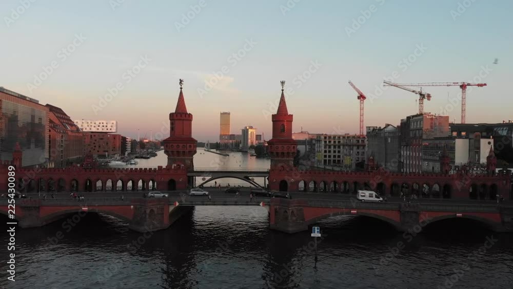 Aerial panoramic view of the Oberbaum Bridge in Berlin, Germany with drone flying over the Spree River during the sunset Aerial panoramic view of the Oberbaum Bridge in Berlin, Germany with drone flying over the Spree River during the sunset