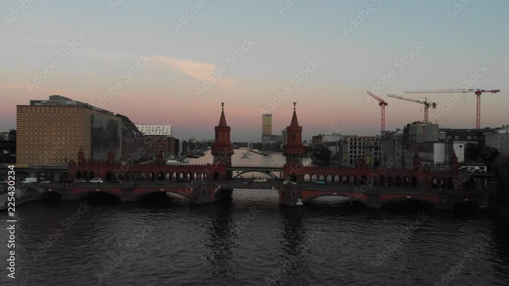 Aerial panoramic view of the Oberbaum Bridge in Berlin, Germany with drone flying over the Spree River during the sunset Aerial panoramic view of the Oberbaum Bridge in Berlin, Germany with drone flying over the Spree River during the sunset