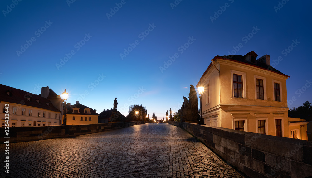 Prague at night, historical houses at the entrance to Charles Bridge