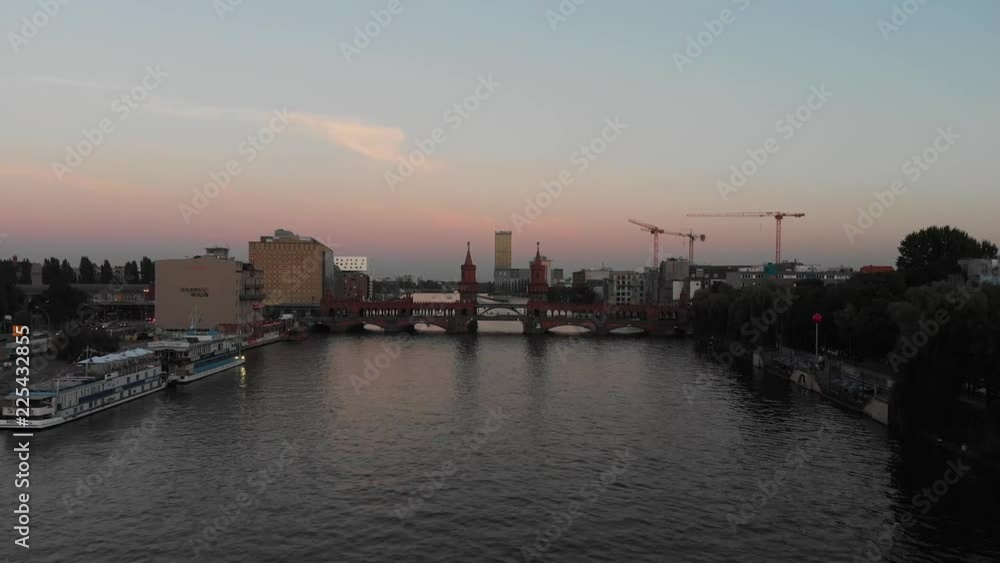 Aerial panoramic view of the Oberbaum Bridge in Berlin, Germany with drone flying over the Spree River during the sunset Aerial panoramic view of the Oberbaum Bridge in Berlin, Germany with drone flying over the Spree River during the sunset