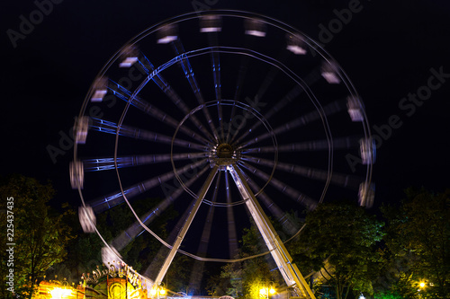 a Ferris wheel in a night park on a long exposure
