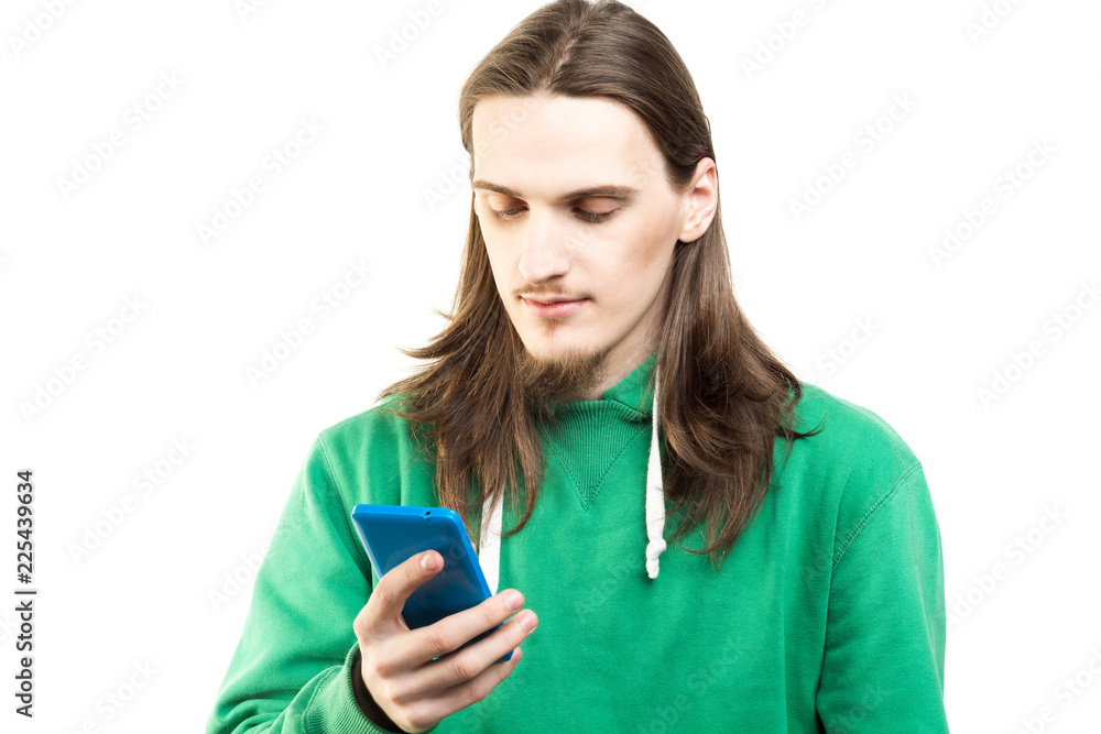 Portrait of young handsome man in green hoodie looking at the camera agains white background. Lifestyle, people and technology concept Portrait of young handsome man in green hoodie looking at the camera agains white background. Lifestyle, people and technology concept