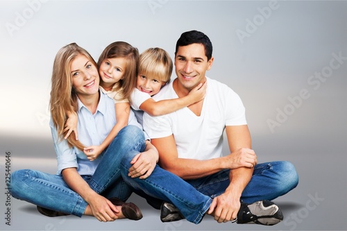 Beautiful smiling family sitting at sofa on
