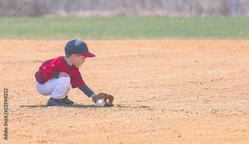 Child Fields a Ground Ball During a Baseball Game © J. Novack
