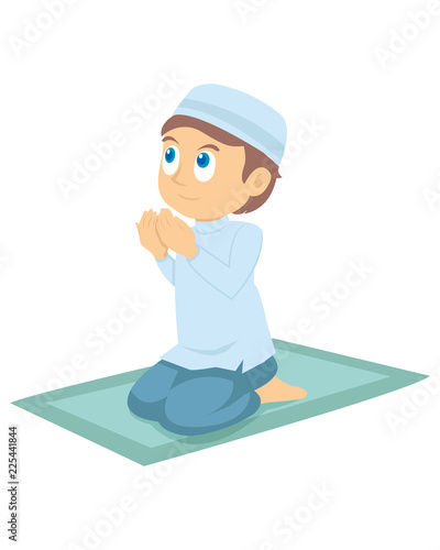 A young muslim boy praying
