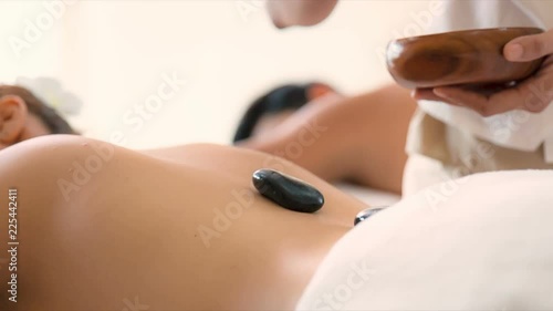Young asian woman receiving a massage in modern spa treatment place. 