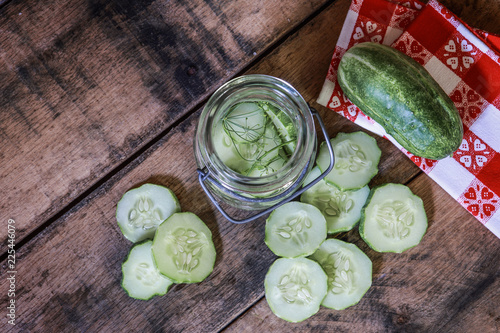 overhead flat lay image of sliced cucumber pickles