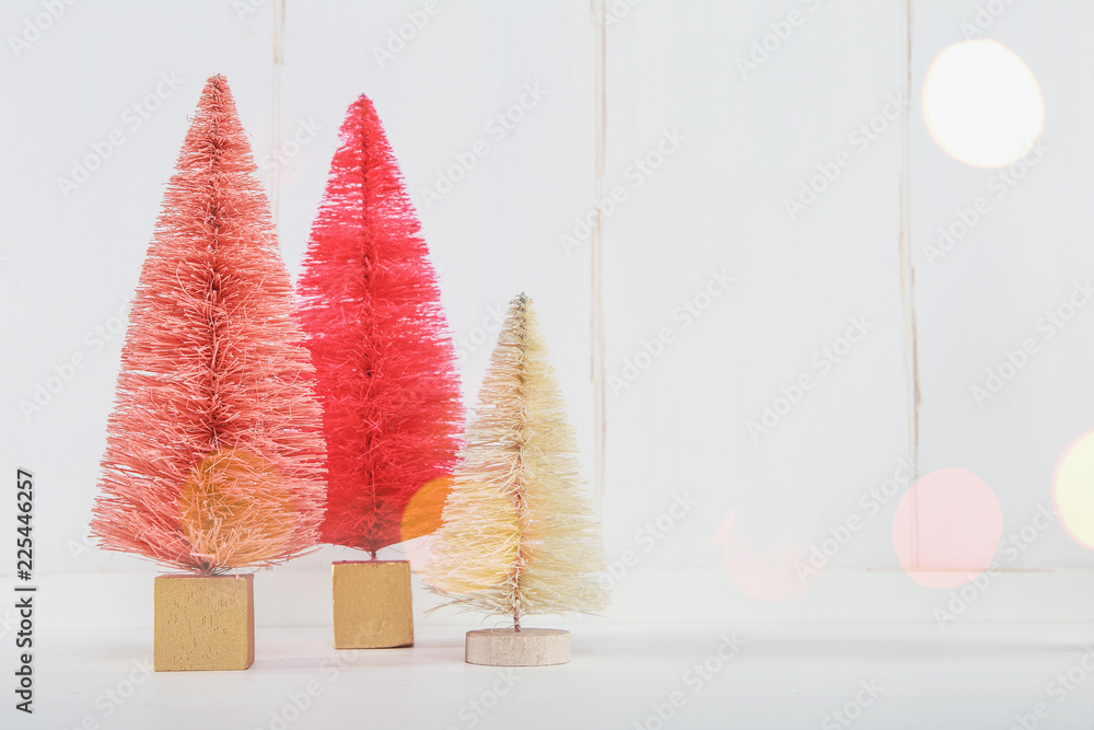 Miniature Christmas trees on a white wooden background Miniature Christmas trees on a white wooden background