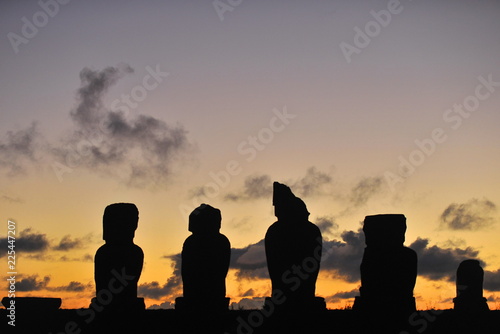 Easter Island. Statues of moai on the shore of the Pacific Ocean in the evening.