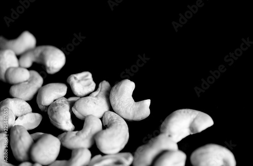 Cashew nuts on a dark background close up. Black and white