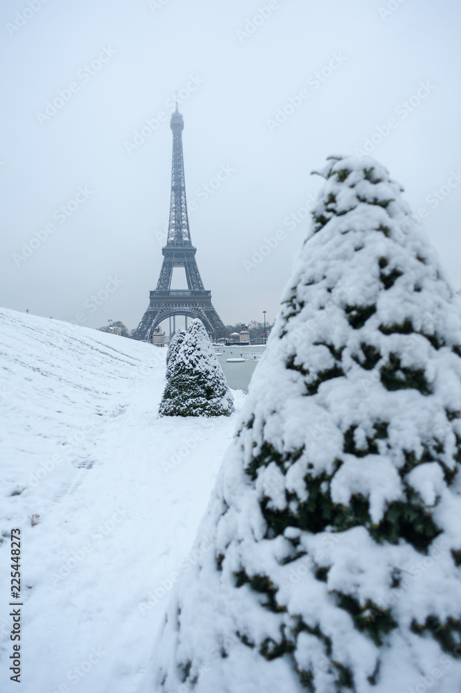 Eiffel tower under the snow in winter in Paris