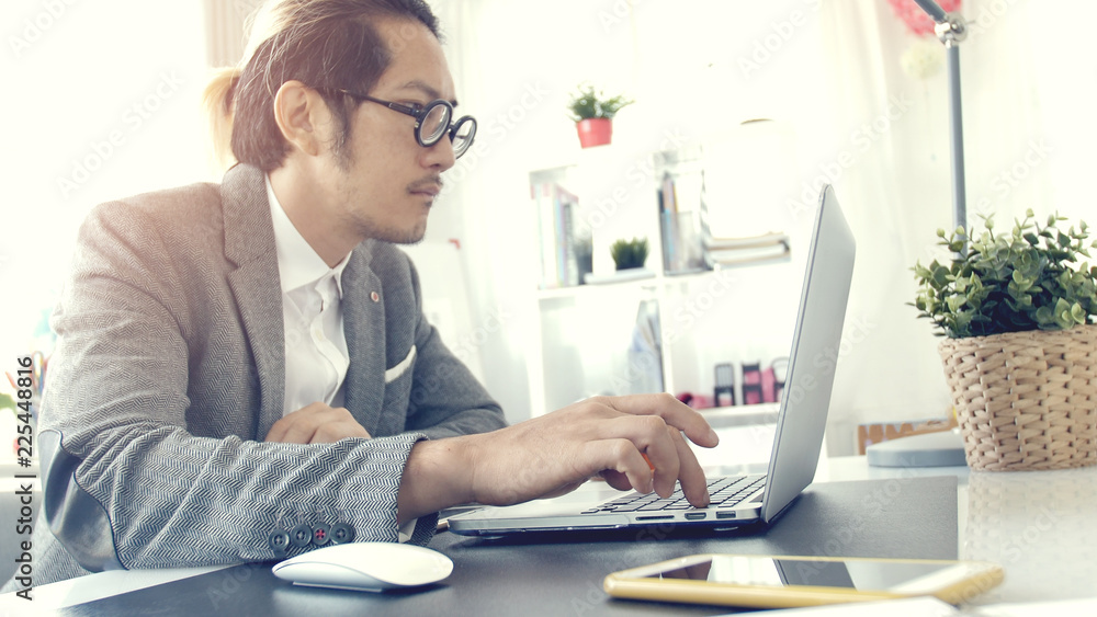 Asian business man wearing eyeglass in office. Asian business man wearing eyeglass in office.