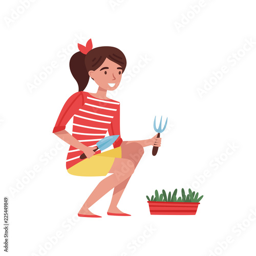 Smiling teenager girl with small shovel and rake in hands, caring for garden plant. Nature theme. Flat vector design