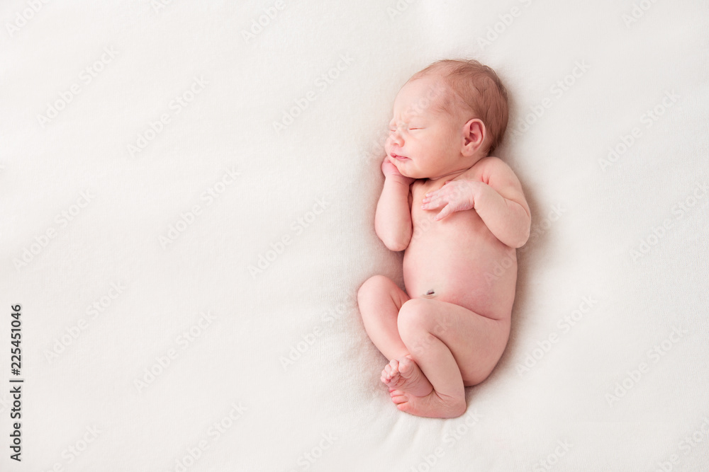 Funny newborn baby sleeping peacefully naked. Top view Stock Photo | Adobe  Stock