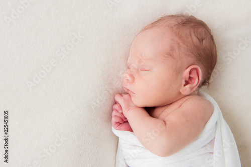 Cute newborn baby sleeping on white background. Top view