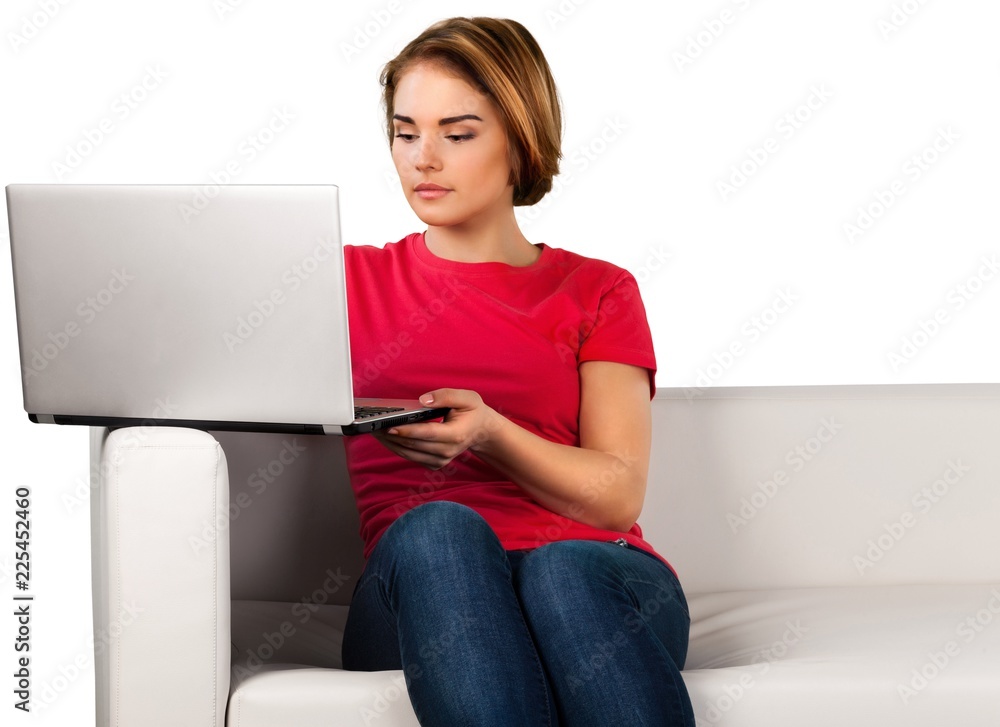 Portrait of a Woman Using her Laptop on a Couch Portrait of a Woman Using her Laptop on a Couch